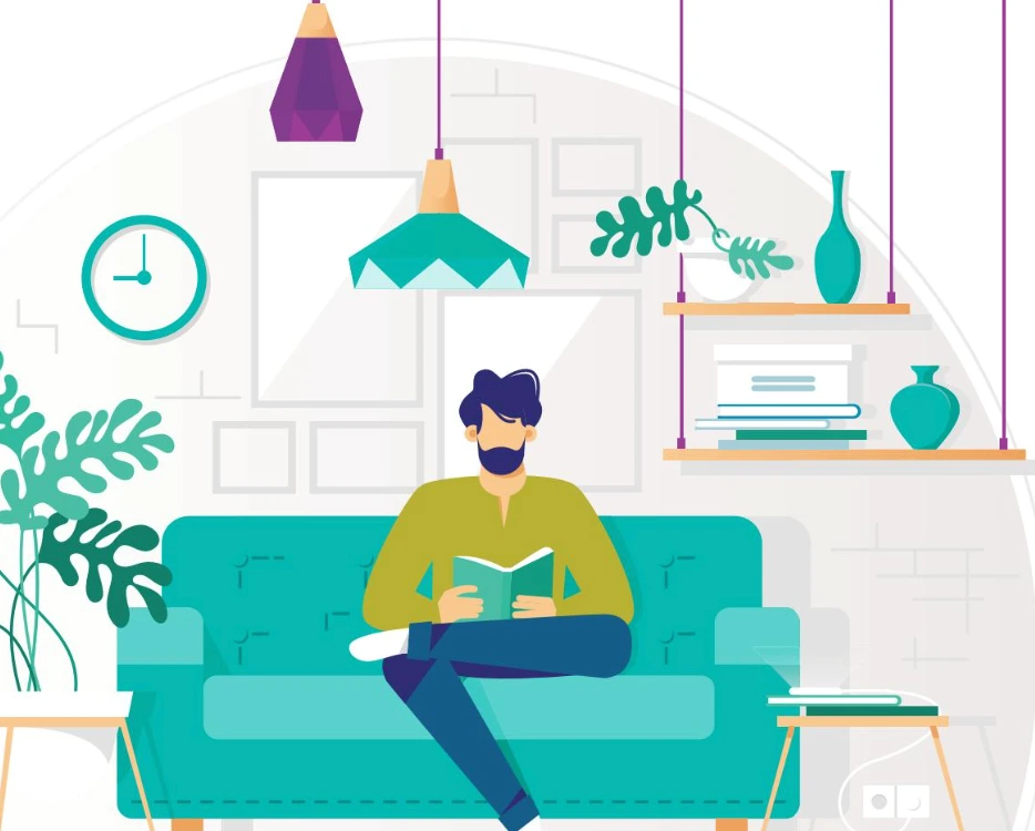 A person reading a book on a turquoise sofa in a room with plants and shelves